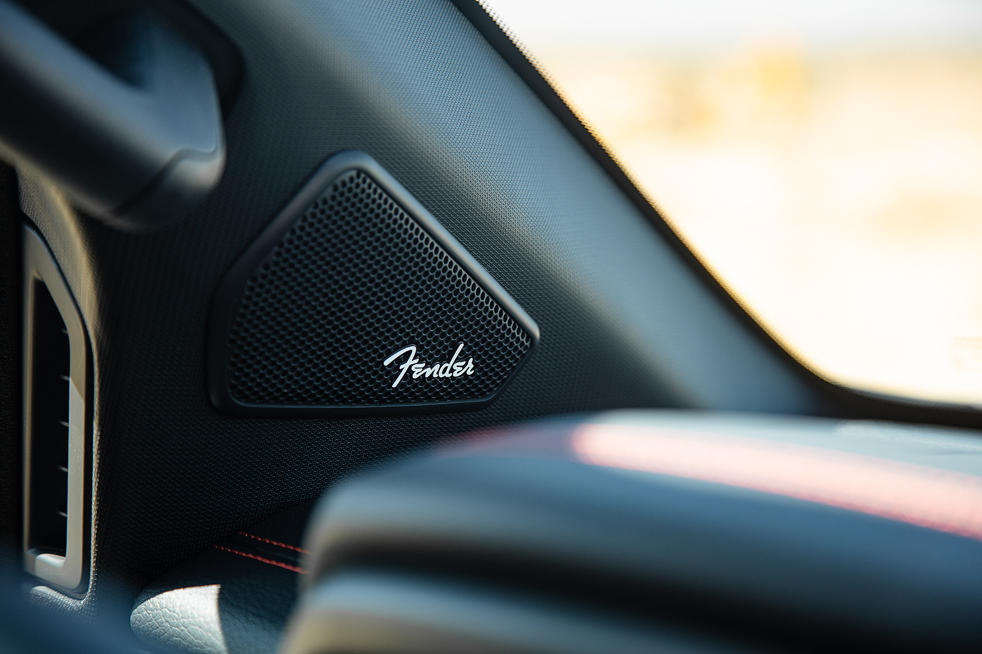 Close-up shot of a Fender speaker inside a Nissan Titan Pro 4x